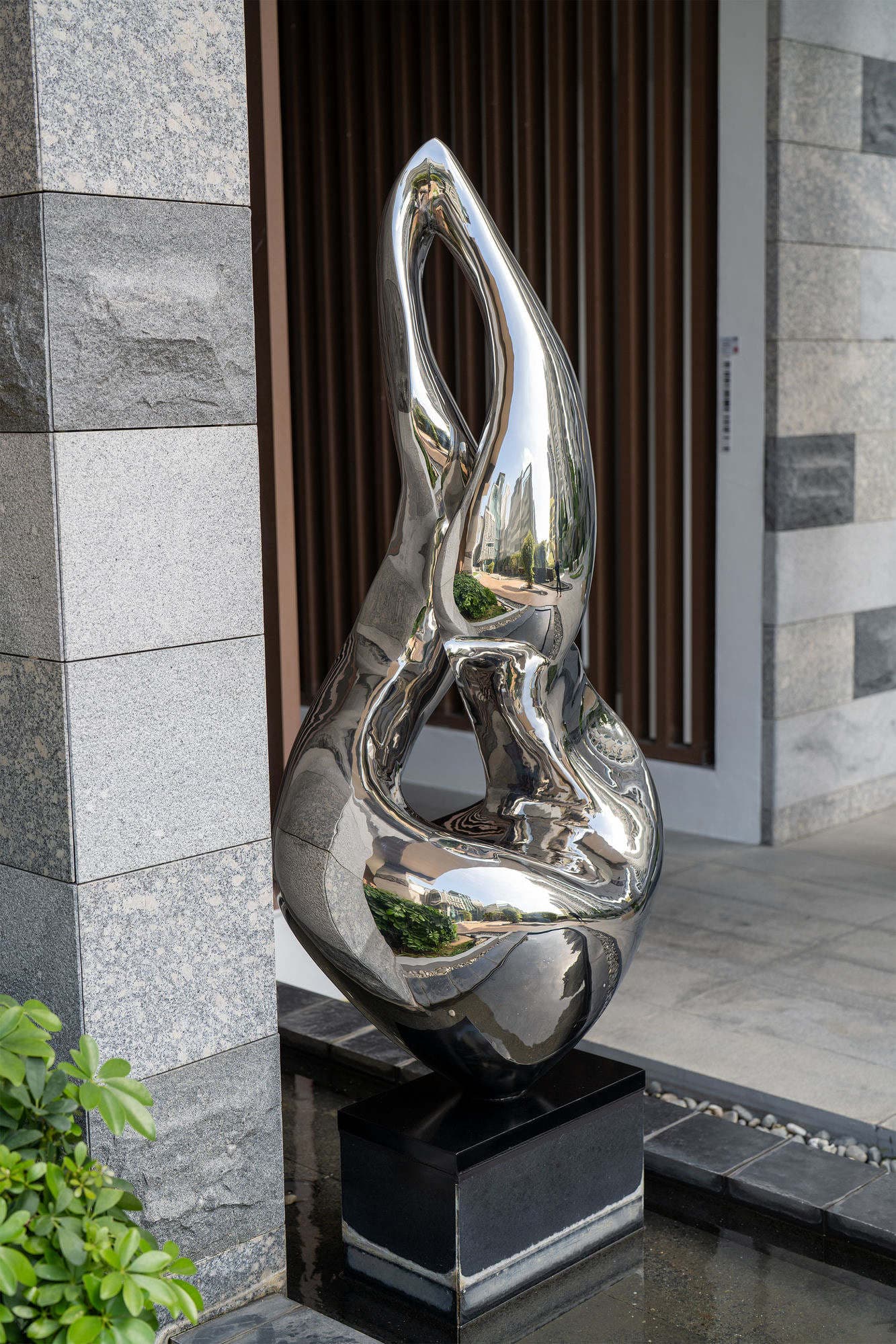 The same sculpture seen from an angle, showing the open loop through the centre of the form