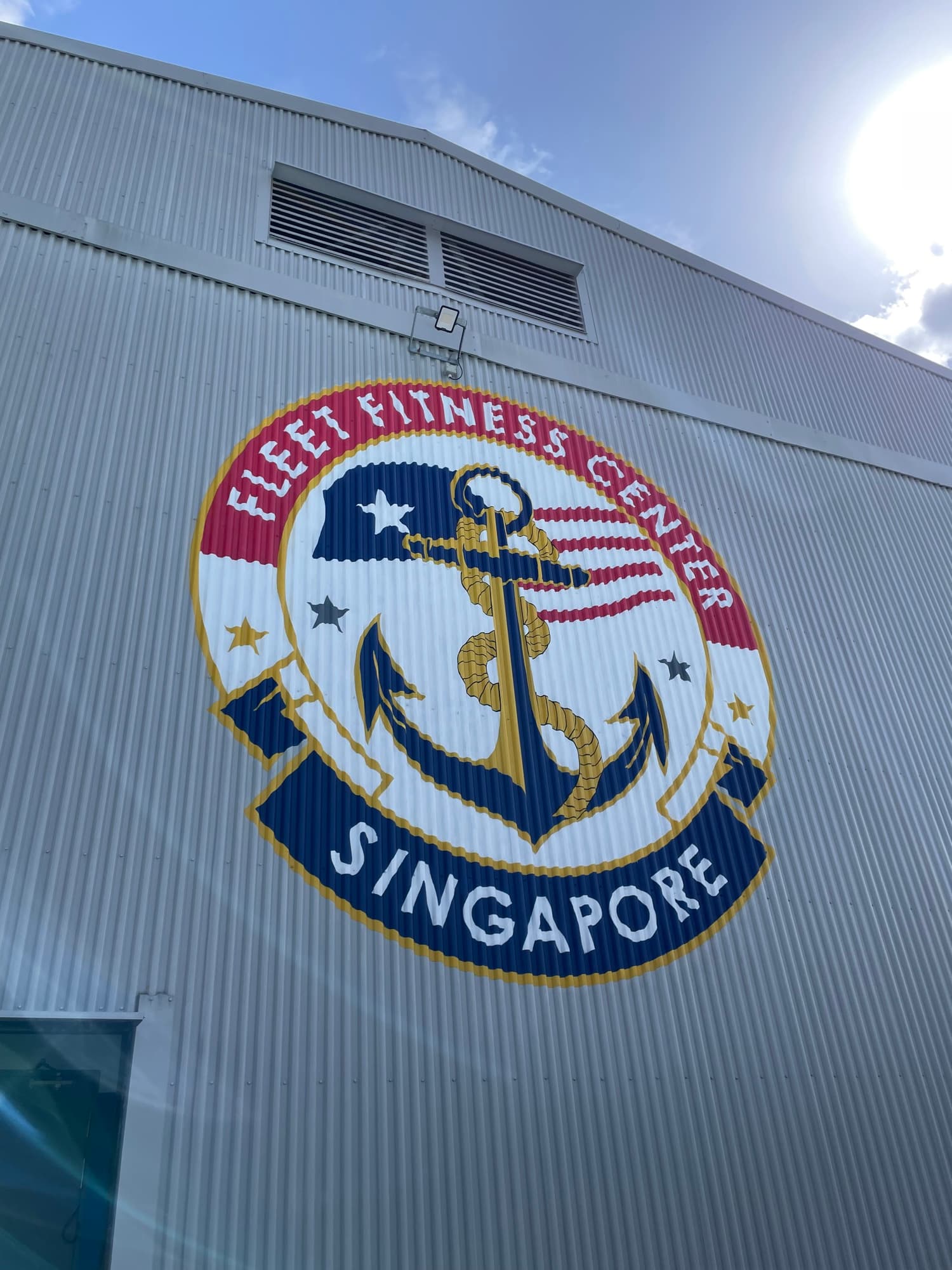 The finished emblem hand painted across the corrugated steel facade